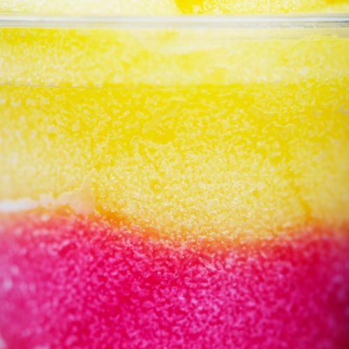 Photo by Electra Studio Close-up of a yellow and red slushie showcasing its frosty texture and vibrant colors.